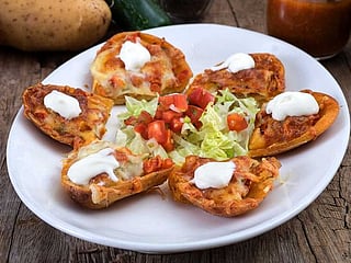 Cajun cheese potato skins with tomato and red onion salad