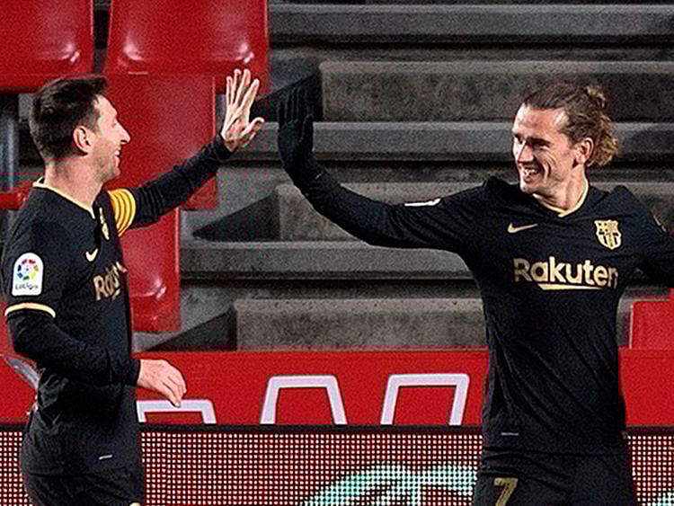 Messi and Griezmann celebreate for Barcelona against Granada