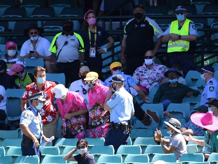 Police remove a group of spectators from their seats after Mohammed Siraj of India complained to umpires of being racially abused during day four of the third test match between Australia and India at the SCG in Sydney 