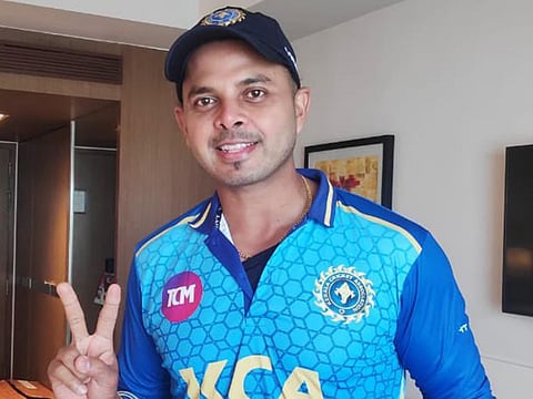 Santakumaran Sreesanth flashes the V-sign on his comeback for the Kerala team after serving a prolonged ban.