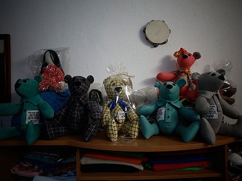 Stuffed bears ready for delivery sit in the home workshop of Erendira Guerrero, who has been making the bears for people who lost a family member to COVID-19 using one of the deceased's articles of clothing, in Ciudad Juarez, Mexico, Monday, Jan. 11, 2021.