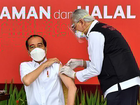 Indonesian President Joko Widodo receives a shot of the COVID-19 vaccine at the Merdeka Palace in Jakarta, on January 13, 2021. 