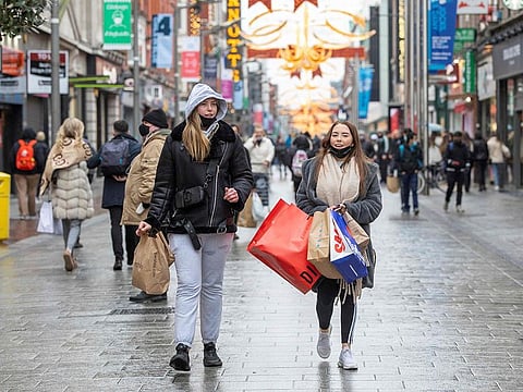 File photo: Pedestrians shop in advance of a new coronavirus lockdown in Dublin on December 31, 2020.