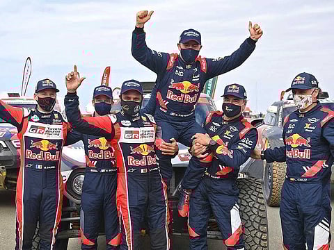 French driver Stephane Peterhansel (C) celebrates with teammates following his victory in the Dakar Rally in Saudi Arabia.