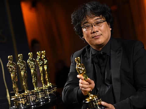 In this file photo taken on February 10, 2020 South Korean film director Bong Joon-ho poses with his engraved awards as he attends the 92nd Oscars Governors Ball at the Hollywood & Highland Center in Hollywood, California. Palme d'Or and Oscar winner, South Korean director Bong Joon-ho will preside over the jury of the 78th edition of the Venice Film Festival.