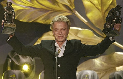 German illusionist Siegfried Fischbacher of the duo "Siegfried & Roy" holds their trophies after receiving the World Entertainment Award at the World Award 2003 ceremony in Hamburg, northern Germany, on October 22, 2003.
