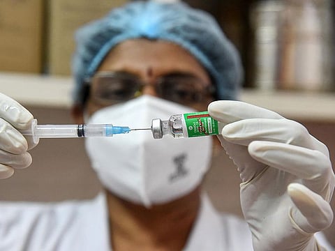 A medic prepares the dose of COVID-19 vaccine before giving it to a beneficiary, at Ernakulam Government General Hospital in Kochi. 
