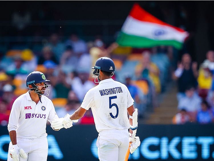 Washington Sundar (R) is congratulated by Shardul Thakur