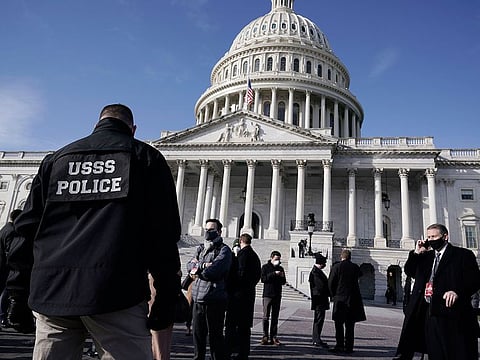 High level security officials make a survey of the East Front of the Capitol after an announcement of security problems during a rehearsal for the 59th Presidential Inauguration at the U.S. Capitol in Washington, Monday, Jan. 18, 2021.