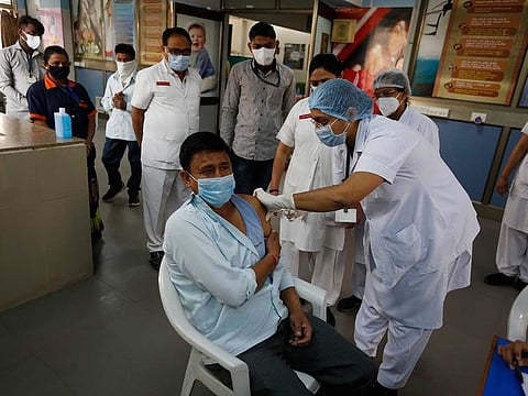 A hospital staff receives a COVID-19 vaccine at a government Hospital in Ahmedabad, India, Saturday, Jan. 16, 2021.