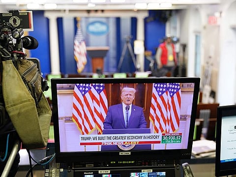An image of US President Donald Trump speaking in a video released on YouTube is seen on a monitor in the Brady Briefing Room of the White House in Washington, DC, on January 19, 2021.