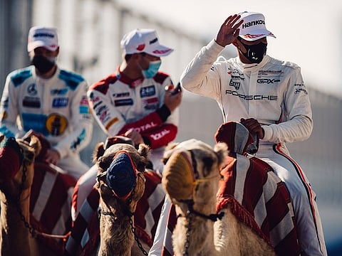 Members of GPX Racing team take a camel ride to the podium after recording their first win in 24 hours of Dubai endurance earlier this week.