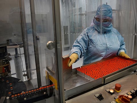 Technician Mayelin Mejias works with the 'Soberana 02' COVID-19 vaccine at the packaging processing plant of the Finlay Vaccine Institute in Havana. 