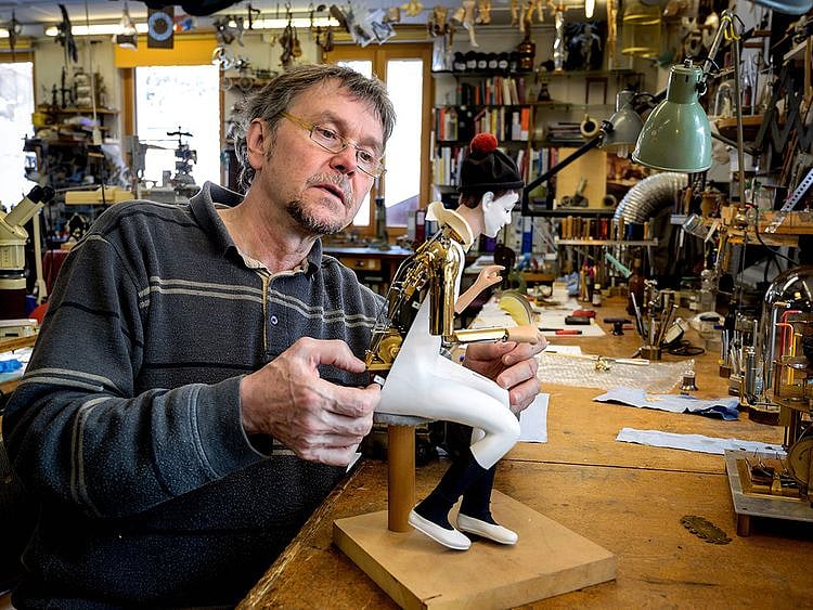 Swiss master Francois Junod working on a moving mechanical artwork, in his workshop in Sainte-Croix. 