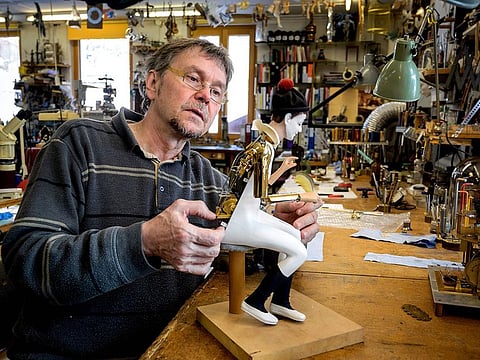 Swiss master Francois Junod working on a moving mechanical artwork, in his workshop in Sainte-Croix. 