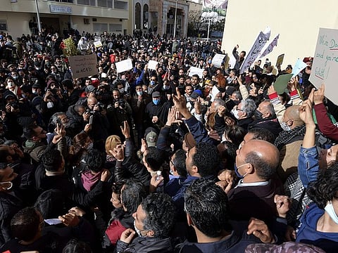Tunisian protesters gesture as they shout slogans during an anti-government demonstration in the capital Tunis, on January 23, 2021. 