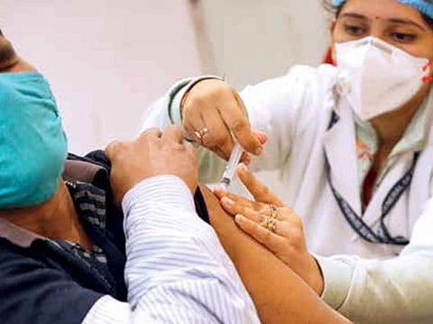 A health worker administers a Covid-19 vaccine to a person at a hospital in New Delhi