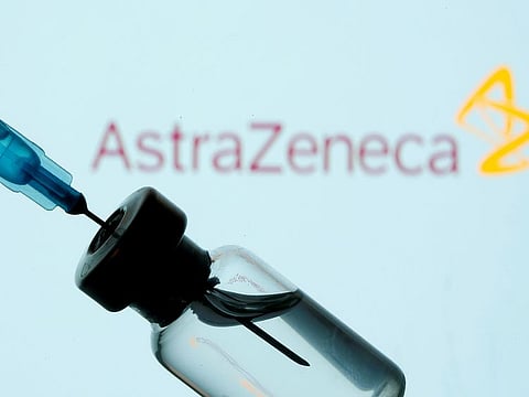A vial and sryinge are seen in front of a displayed AstraZeneca logo in this illustrationtaken January 11, 2021. 