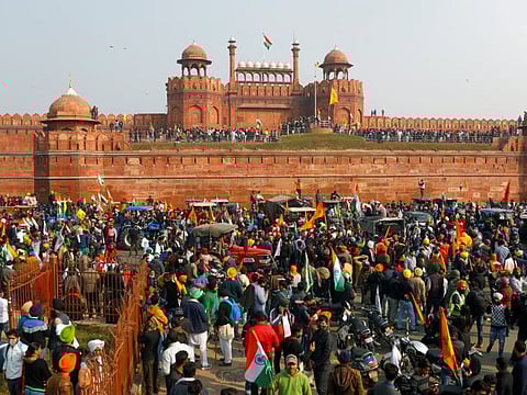 Farmers gather in front of the historic Red Fort during a protest against farm laws introduced by the government, in Delhi, India, January 26, 2021.