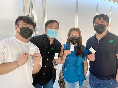  Philippines Consul-General Paul Raymund Cortes with his family members after receiving their vaccination cards.
