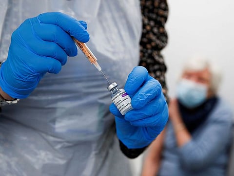 A health worker fills a syringe with a dose of the Oxford/AstraZeneca COVID-19 vaccine at the Appleton Village Pharmacy, amid the coronavirus disease (COVID-19) outbreak, in Widnes, Britain.
