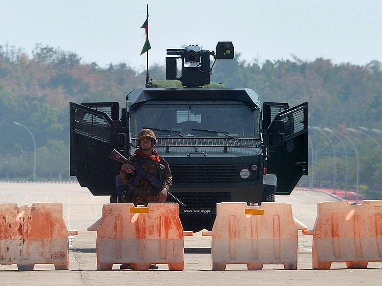 A soldier stands guard on a blockaded road
