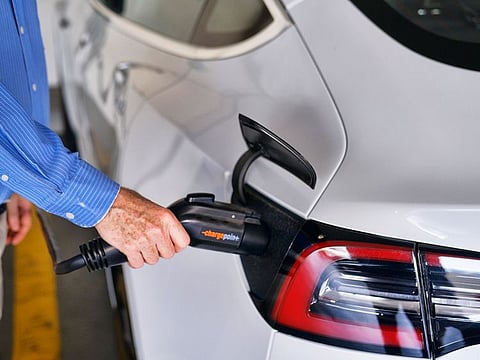 A Tesla being charged. A viral video showed one of the carmaker's employees purportedly telling a customer that an overload in the national grid damaged their electric vehicle.