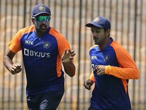 Ravichandran Ashwin (left), who is expected to play a key role in the series, warms up with teammate Mayank Agarwal at the M.A.Chidambaram Stadium on Wednesday.