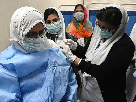 A doctor receives a dose of the Chinese-made Sinopharm COVID-19 vaccine, at a vaccination centre in Lahore on February 3, 2021.