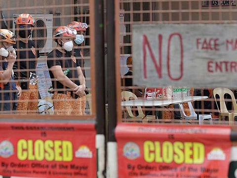 Rescuers stand inside the compound of the TP Marcelo Ice Plant in Navotas, Philippines