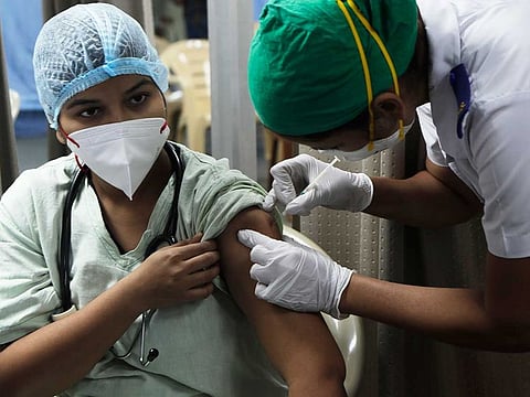 A health worker administers COVID-19 vaccine to another at the Sion Municipal Hospital in Mumbai, India, Tuesday, Feb. 2, 2021.