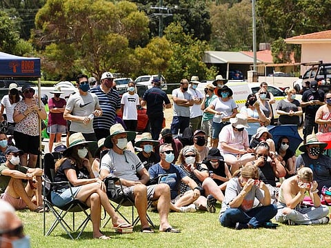 Residents wait to hear a briefing at an evacuation centre in the suburb of Swan View in Perth on February 3, 2021, where they sought shelter from fires that have claimed over 70 homes.