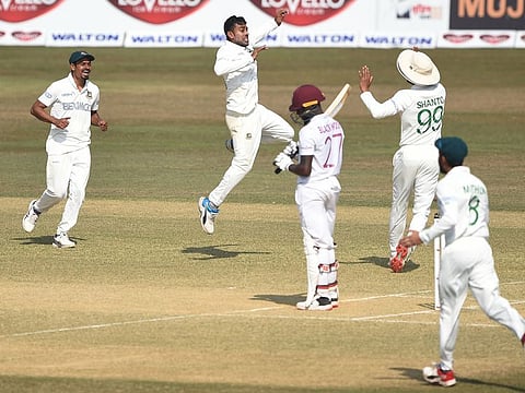 Bangladesh's Mehidy Hasan (second left) and his teammates celebrate the fall of West Indies' Jermaine Blackwood during the third day of the first Test match at the Zohur Ahmed Chowdhury Stadium in Chittagong on Friday.