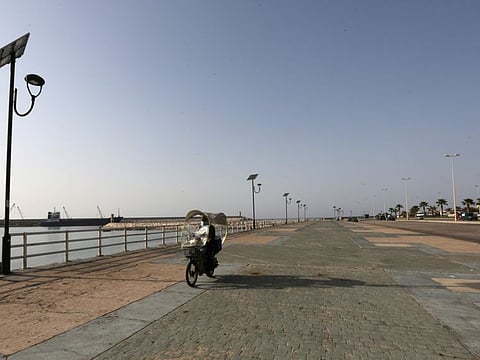 A man wearing a face mask rides on a bike at an empty corniche, during a lockdown to curb the spread of the coronavirus disease (COVID-19), in Sidon, Lebanon February 3, 2021. 