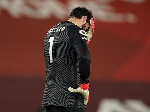 Liverpool's goalkeeper Alisson reacts after Manchester City's Raheem Sterling scored his side's third goal.