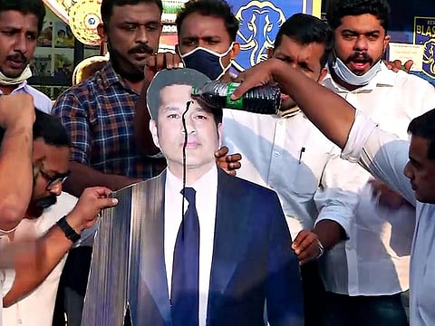 Members of Indian Youth Congress pour black oil on a cut-out of Sachin Tendulkar over his tweet on international personalities tweeting on FarmLaws,  in Kochi, last Friday. 