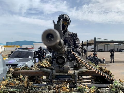 A member of security forces stands behind a weapon. Libya descended into chaos after a 2011 Nato-supported armed revolt that toppled Muammar Gaddafi, who had ruled the country for 42 years.