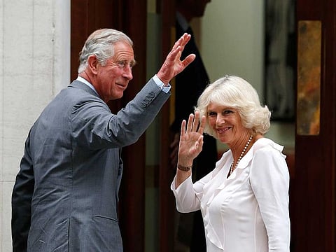 In this file photo dated Tuesday, July 23, 2013, Britain's Prince Charles and his wife Camila, Duchess of Cornwall wave to well wishers as they arrive at St. Mary's Hospital in London. Prince Charles and Camila Duchess of Cornwall have had their first COVID-19 vaccinations, Clarence House said Wednesday Feb. 10, 2021. 