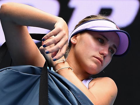A crestfallen Sofia Kenin of the US, the defending champion in Australian Open, leaves the court after crashing out to Estonia's Kaia Kanepi during their women's singles match on Thursday.