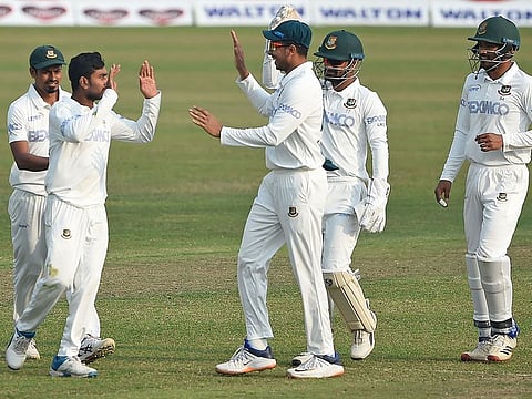 Bangladesh's cricketers celebrate after the dismissal of West Indies' Shayne Moseley 