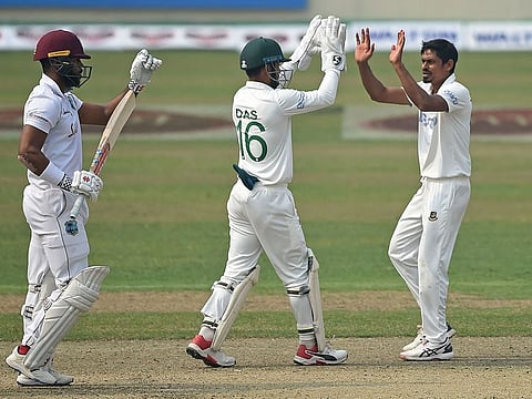Bangladesh's Taijul Islam (R) with wicketkeeper Liton Das celebrate after the dismissal of West Indies' John Campbell (L) in Dhaka