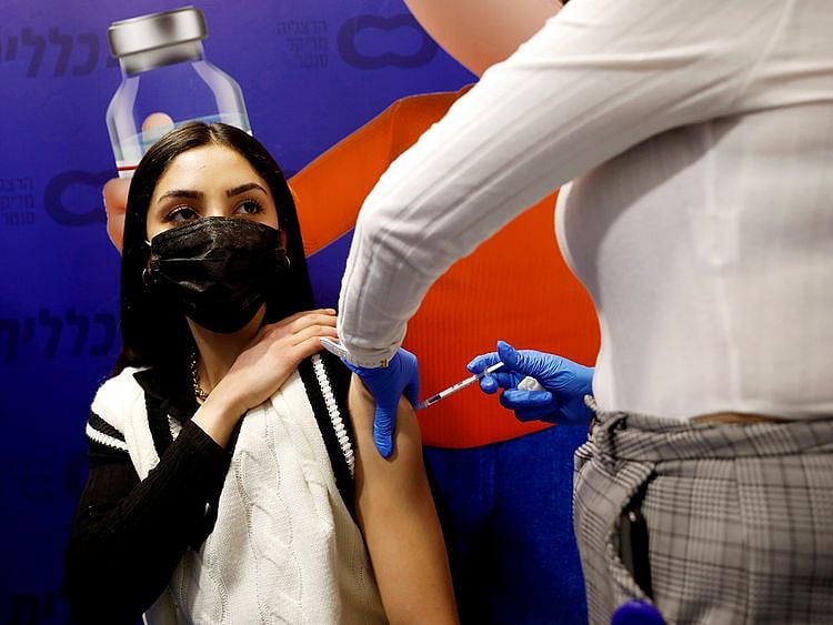 A woman receives a vaccination against the COVID-19