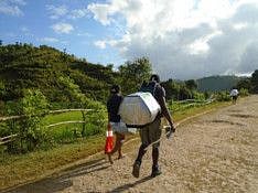 The Smile portable carrier being carried by vaccine distributors in Madagascar.