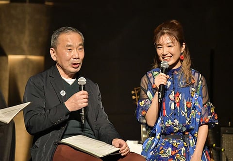 In this photo provided by TOKYO FM, Japanese author Haruki Murakami, left, talks with guitarist Kaori Muraji during a show in Tokyo Sunday, Feb. 14, 2021.