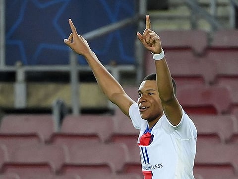 Kylian Mbappe celebrates scoring PSG's fourth against Barcelona.