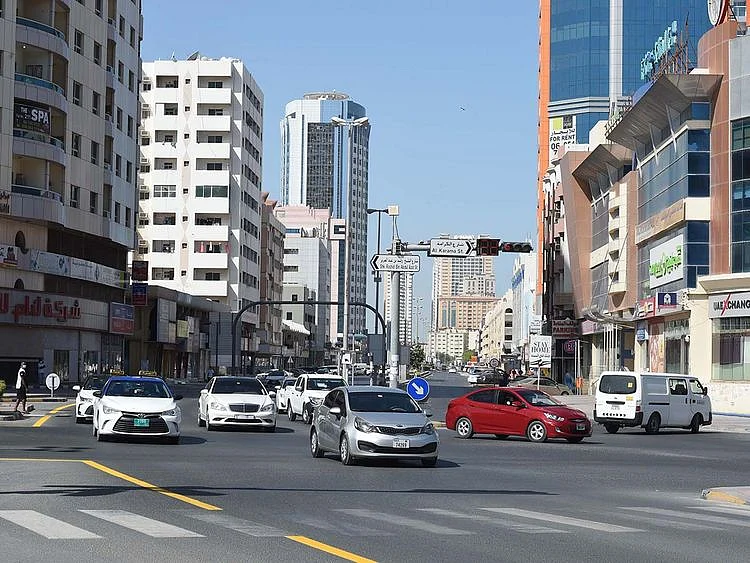 Stock Ajman skyline taxi bus street