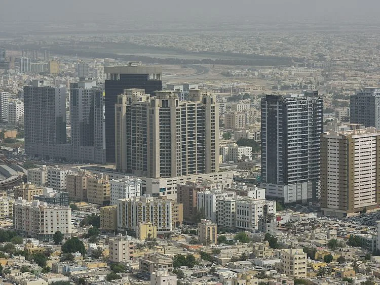 Stock Ajman skyline taxi bus street