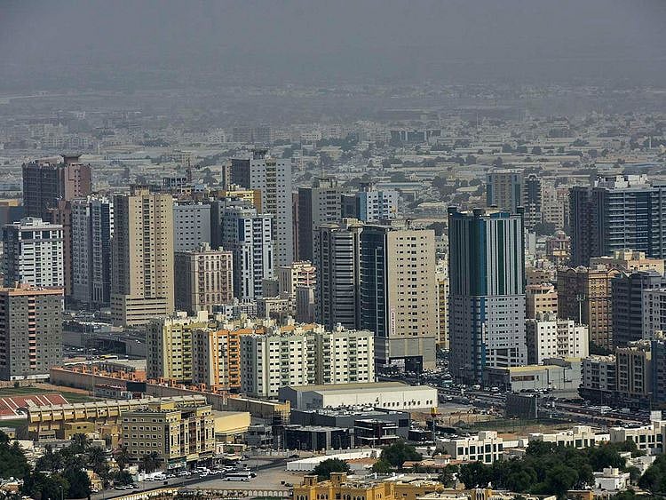 Stock Ajman skyline taxi bus street