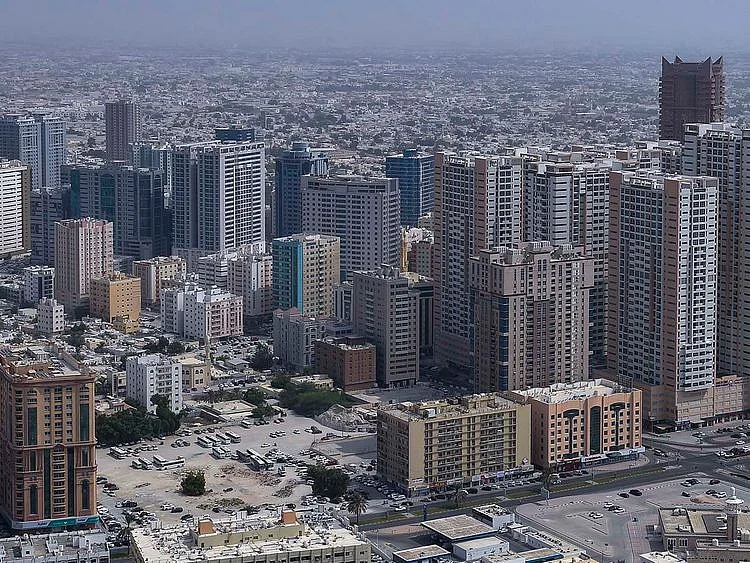 Stock Ajman skyline taxi bus street