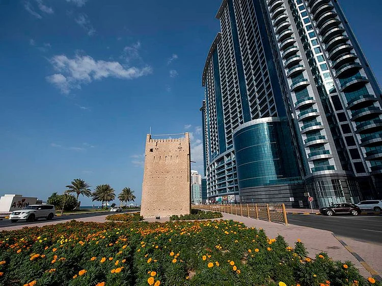 Stock Ajman skyline taxi bus street